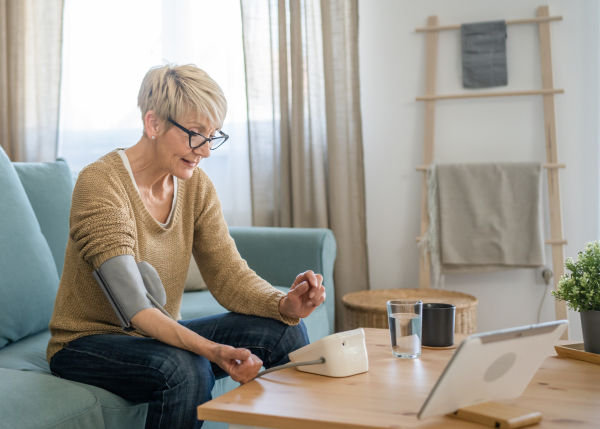 Healthsense24 Platform interface displayed on multiple devices showing senior monitoring dashboard